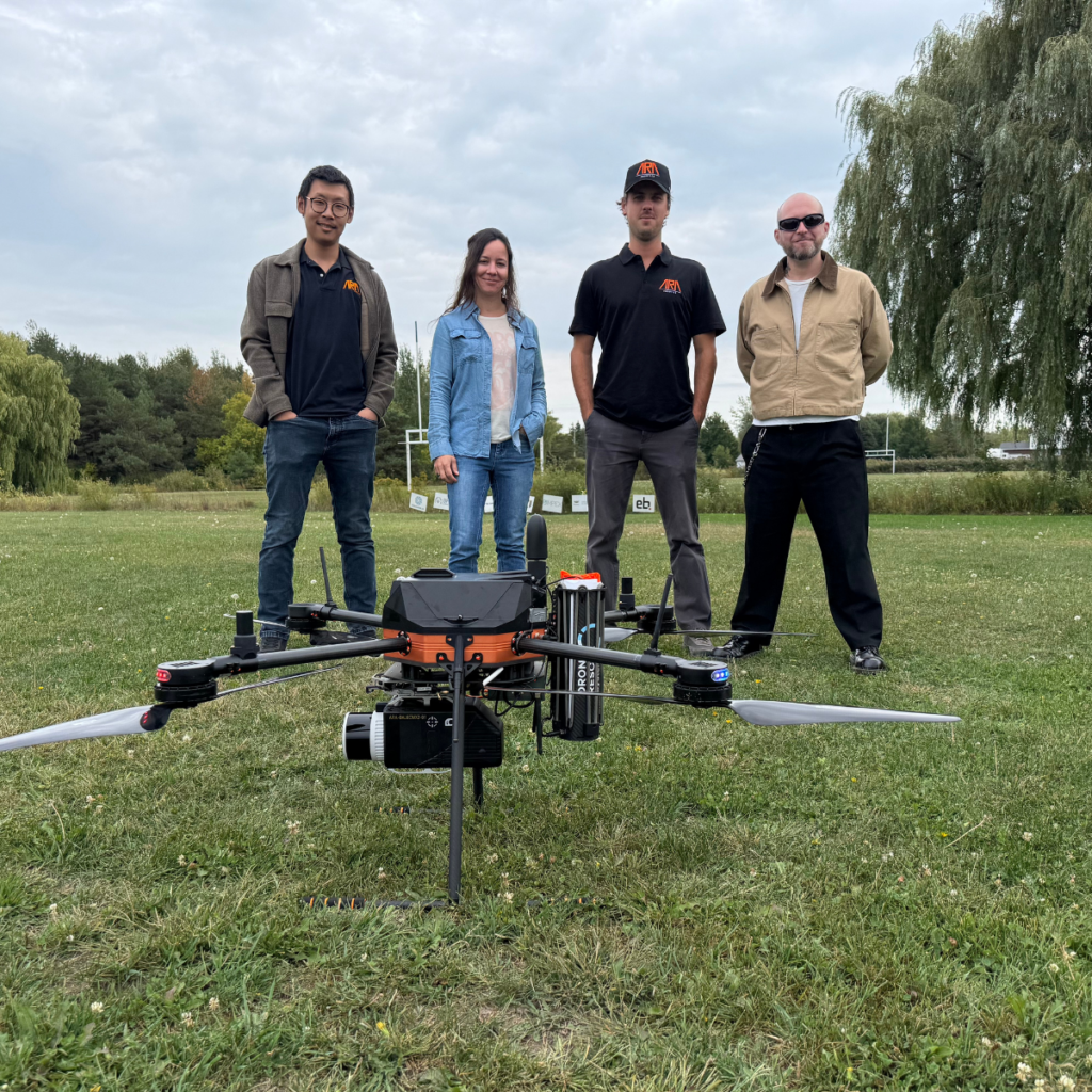 Maude Pelletier, president of Balko, with members of the ARA Robotics team in front of the ARA405 drone equipped with the Connectiv system.